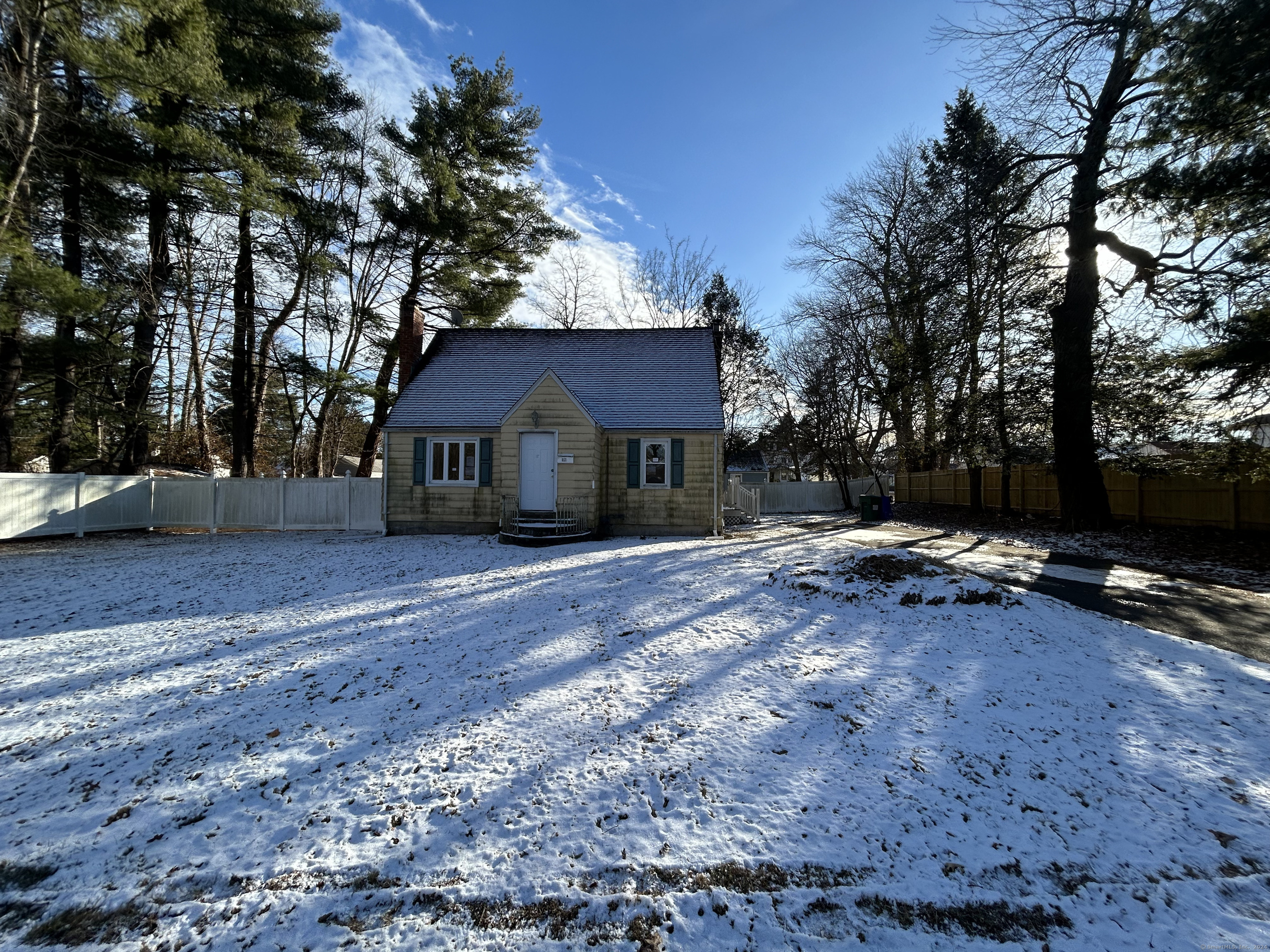 a view of a house with a yard and tree