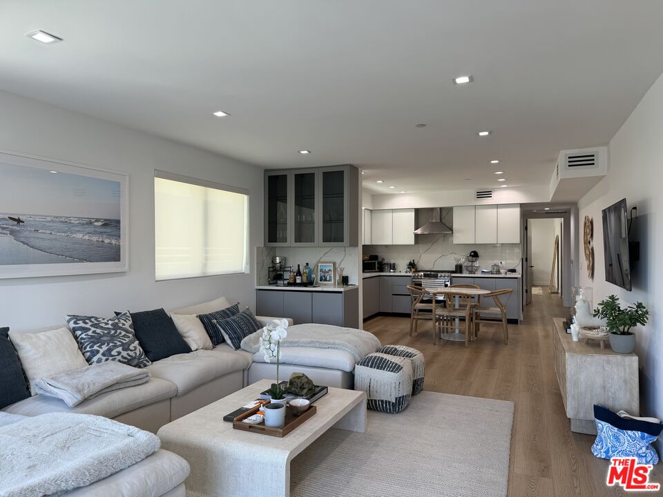 a living room with lots of furniture and kitchen view