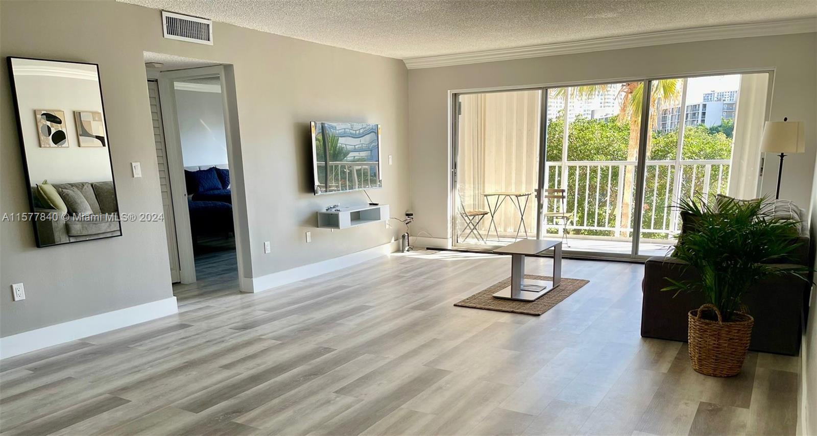 a living room with furniture and large windows