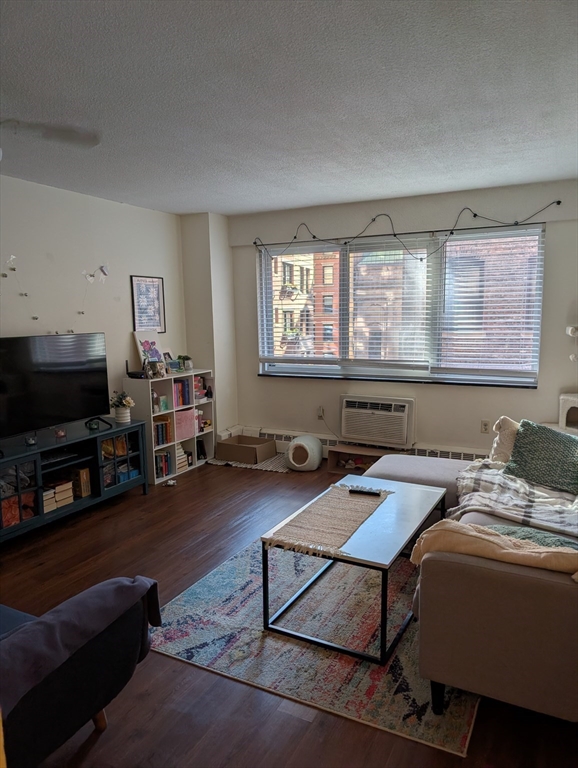 a reading room with furniture a flat screen tv and a window