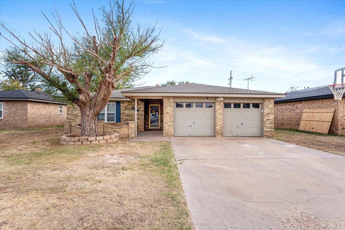 a view of a house with a yard and garage