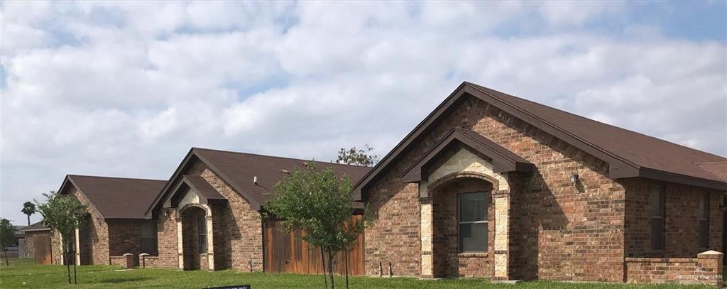 View of property exterior featuring a lawn