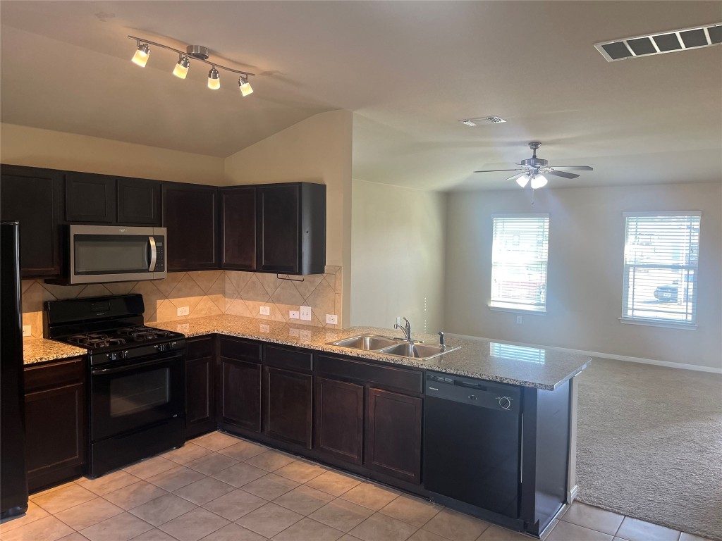 a kitchen with a sink and stove