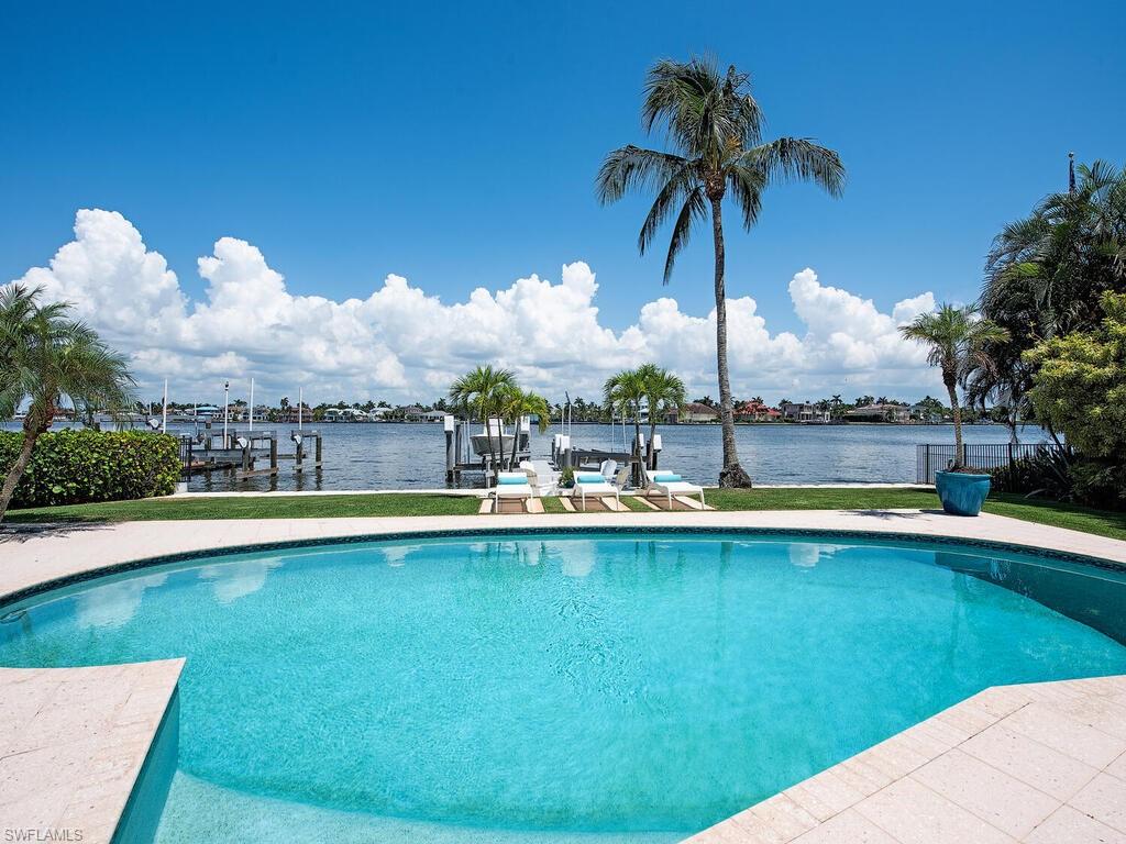 a view of a swimming pool and a yard