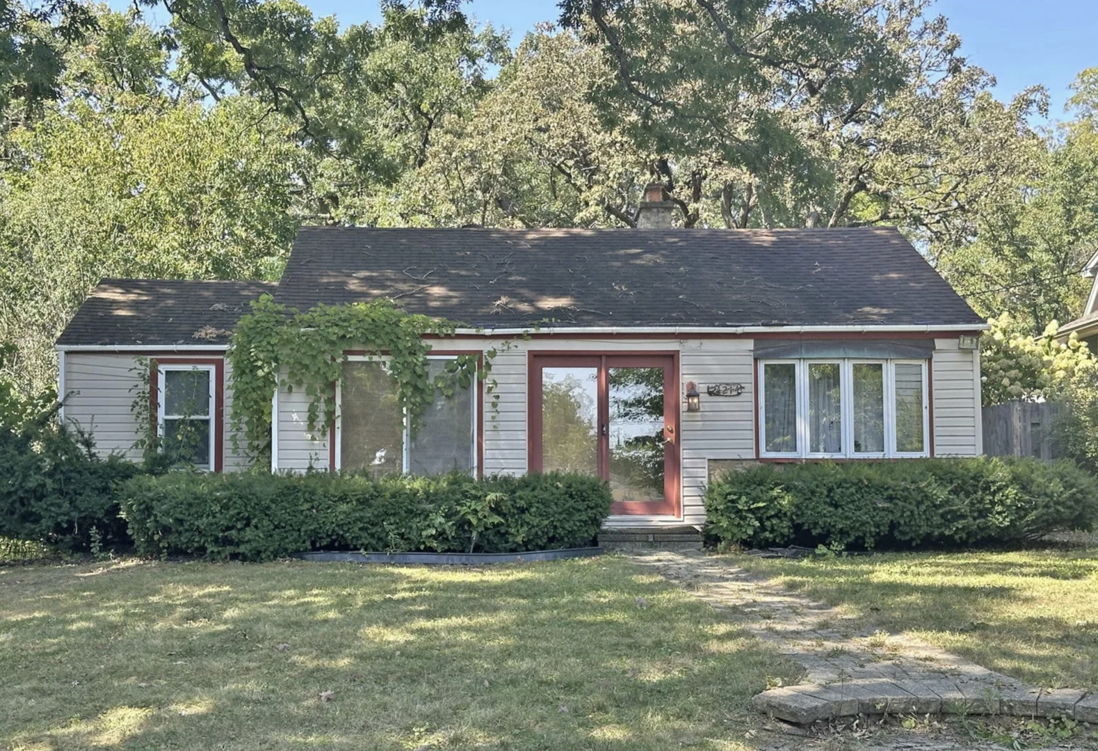 a front view of a house with a garden