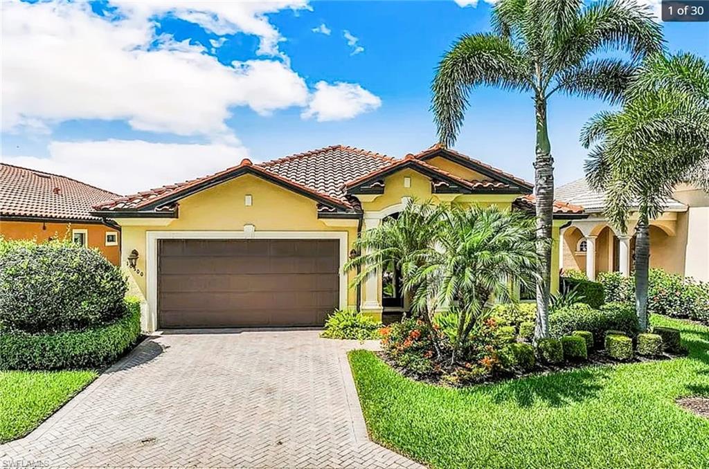 Mediterranean / spanish-style home featuring a garage and a front lawn