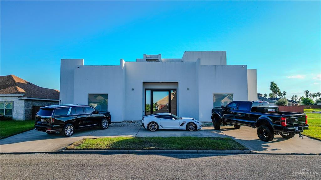 a front view of a house with cars parked