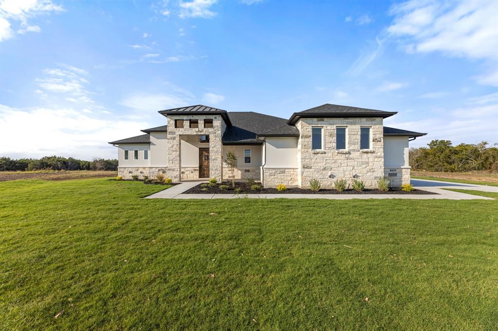 a front view of a house with a yard