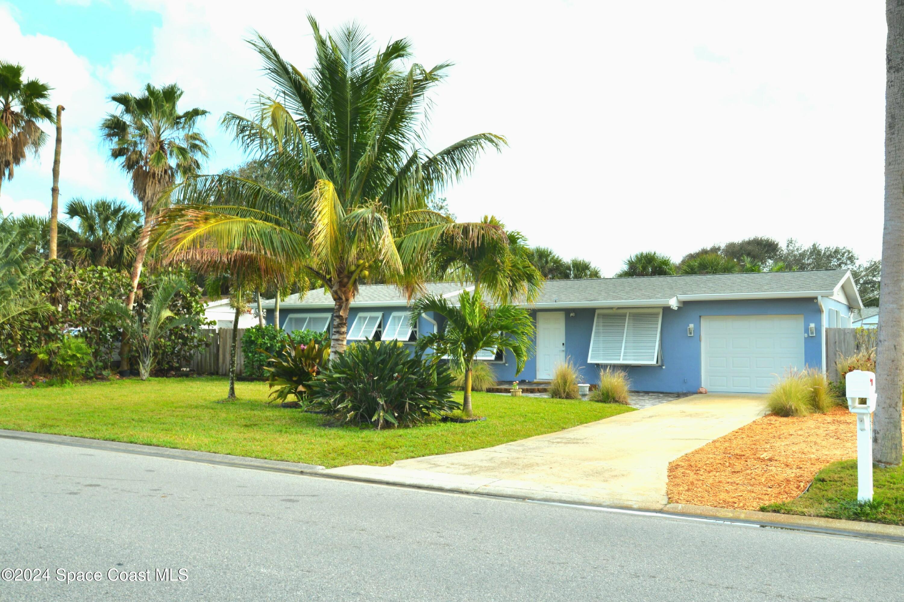 a house with palm tree in front of it