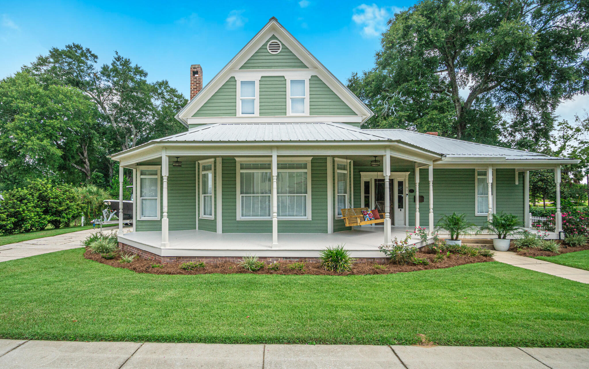 a front view of a house with a yard and outdoor seating