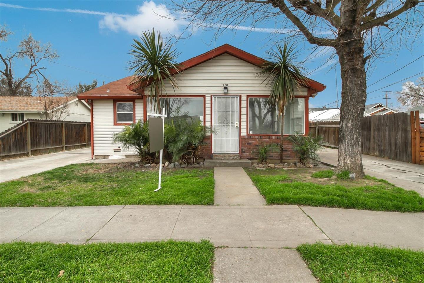 a front view of a house with a yard