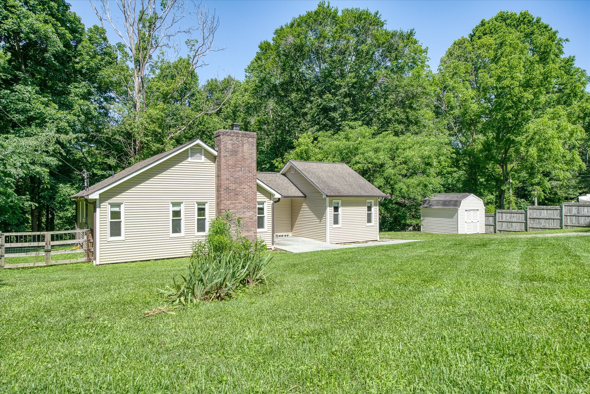 a view of a house with yard and a garden