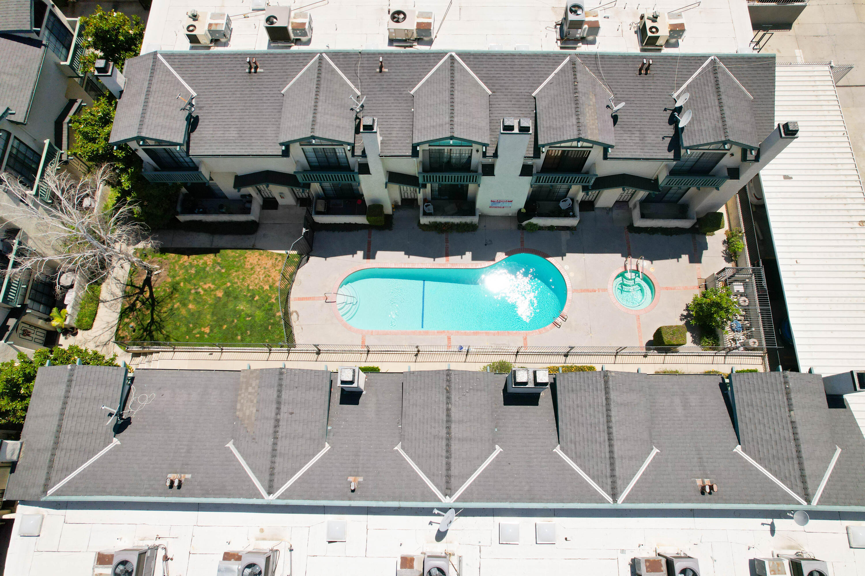 an aerial view of residential houses with outdoor space