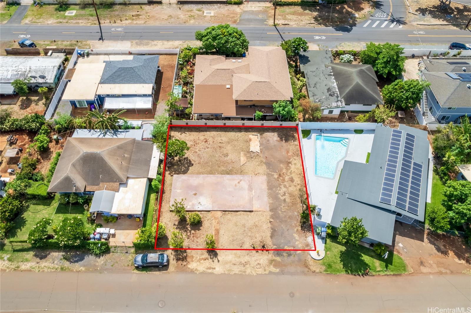 an aerial view of multiple houses with a street