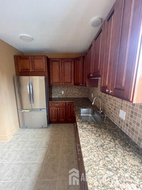 a kitchen with stainless steel appliances granite countertop a refrigerator sink and cabinets