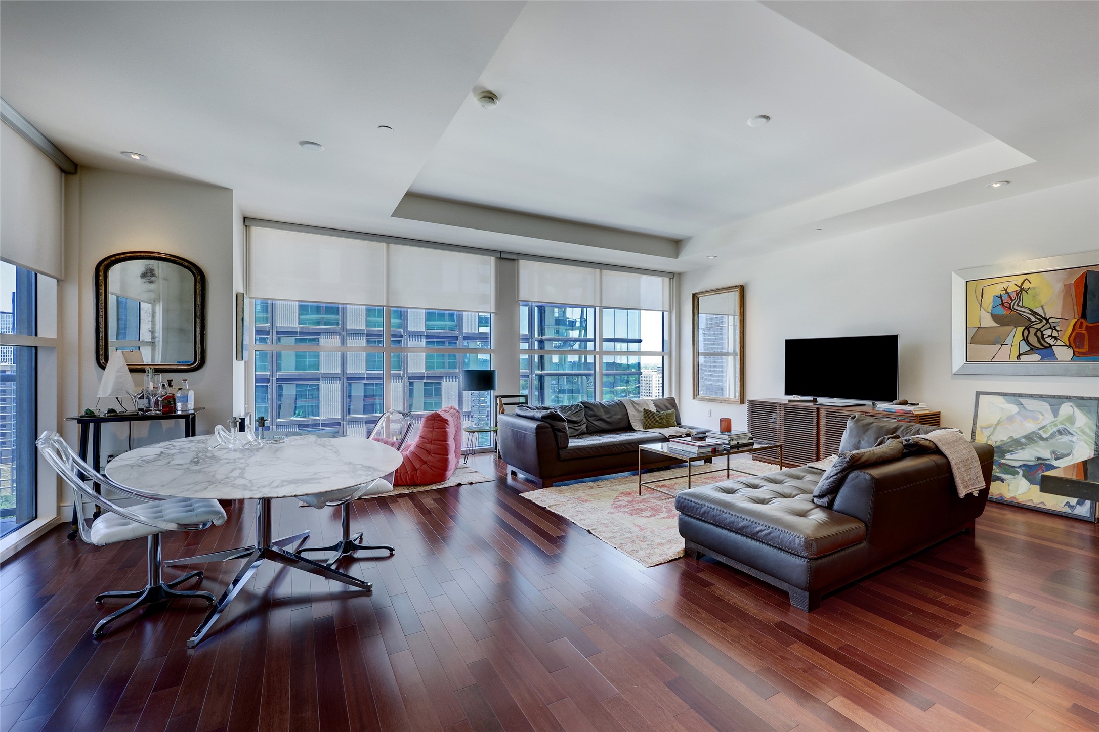 a living room with furniture and wooden floor