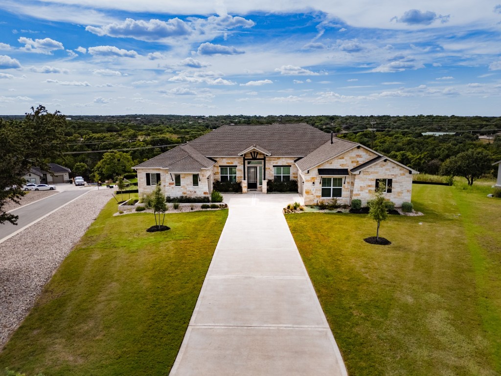 a view of house with swimming pool yard and outdoor seating