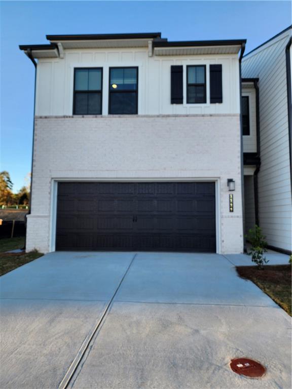 a front view of a house with garage