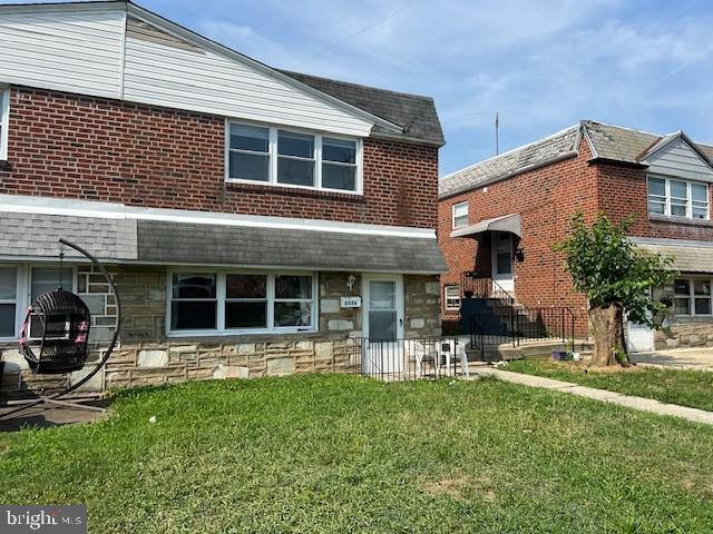 a backyard of a house with yard and outdoor seating