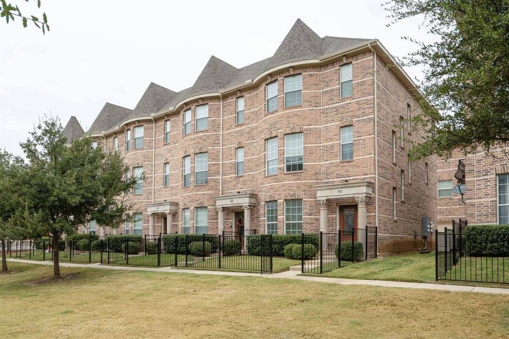 a view of a brick building next to a yard