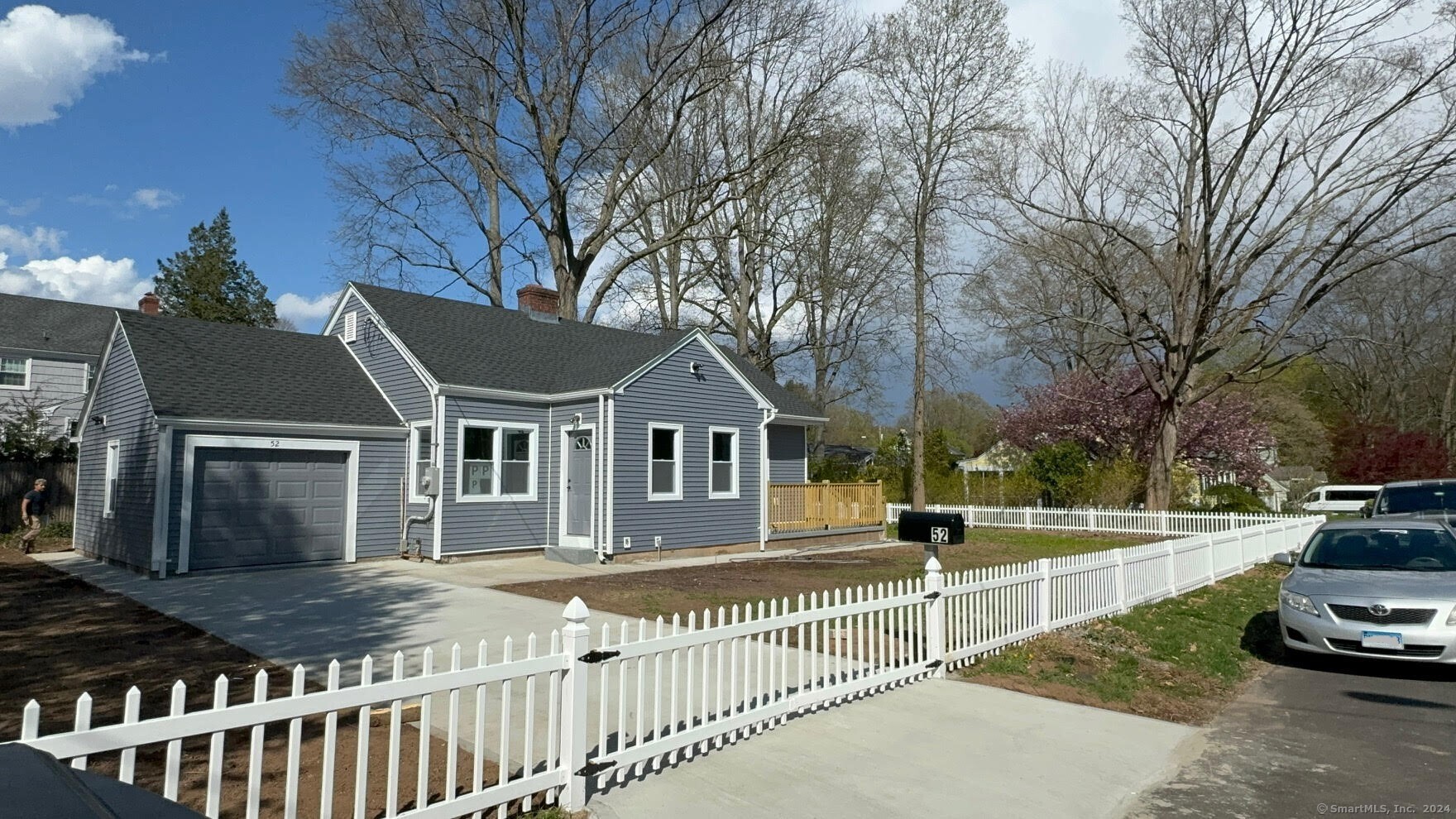 a view of a house with a wooden fence