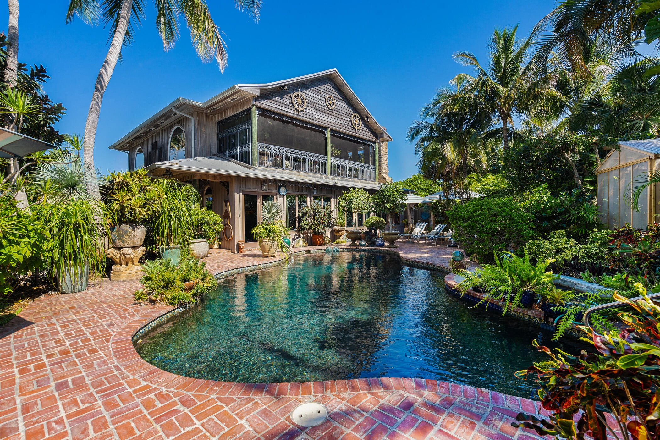 a view of a house with pool and sitting area