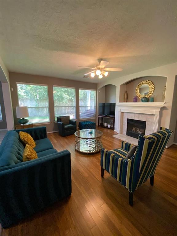 a living room with furniture fireplace and a large window