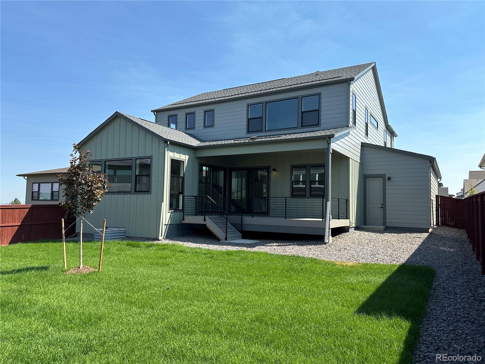 a view of a house with a yard and sitting area