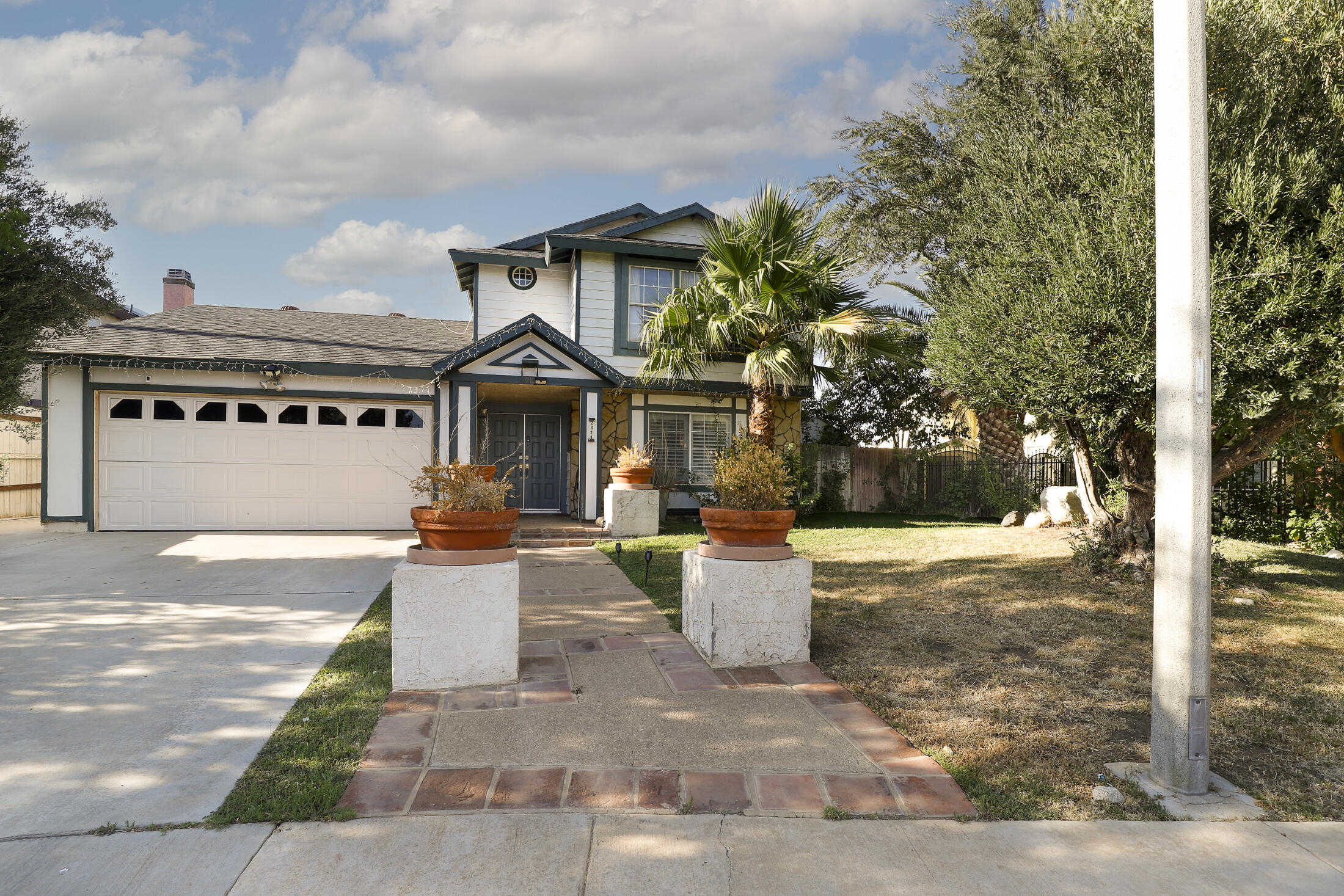 a front view of a house with a yard and many windows