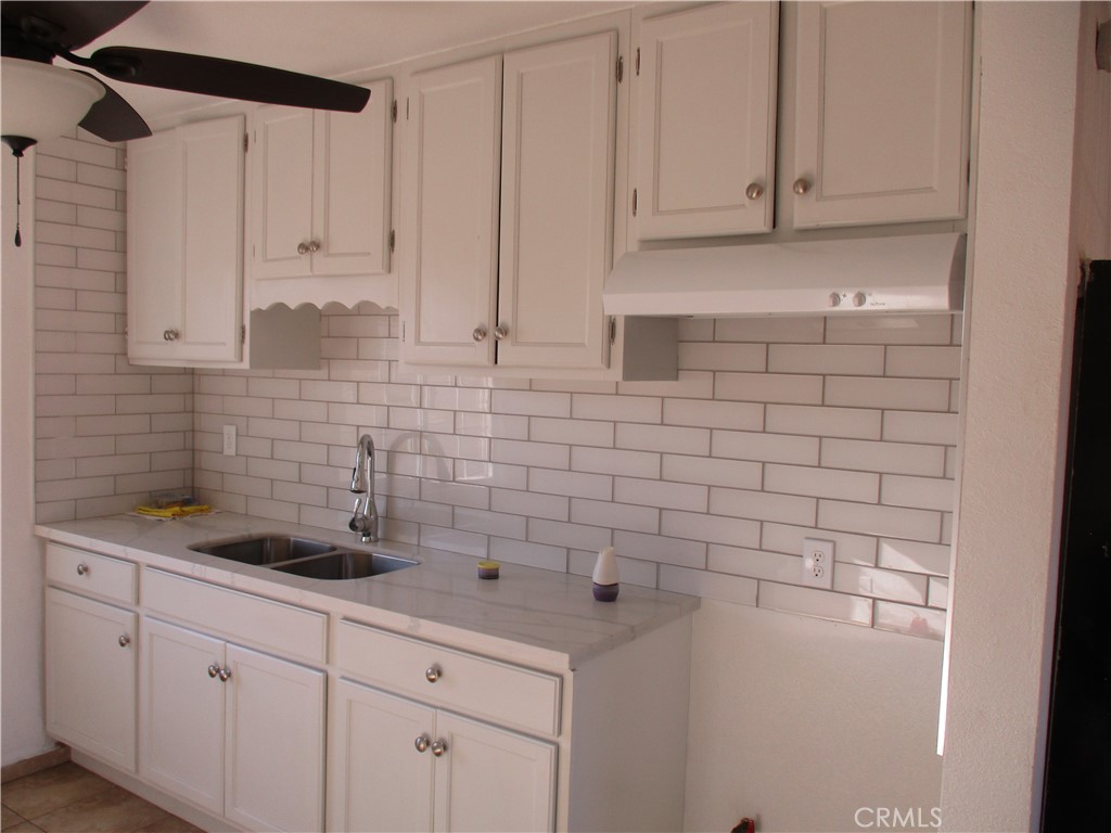 a kitchen with a sink and cabinets