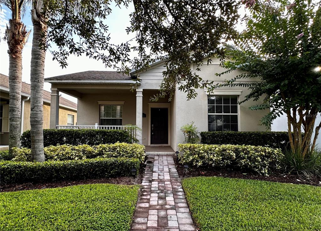 a front view of a house with a garden