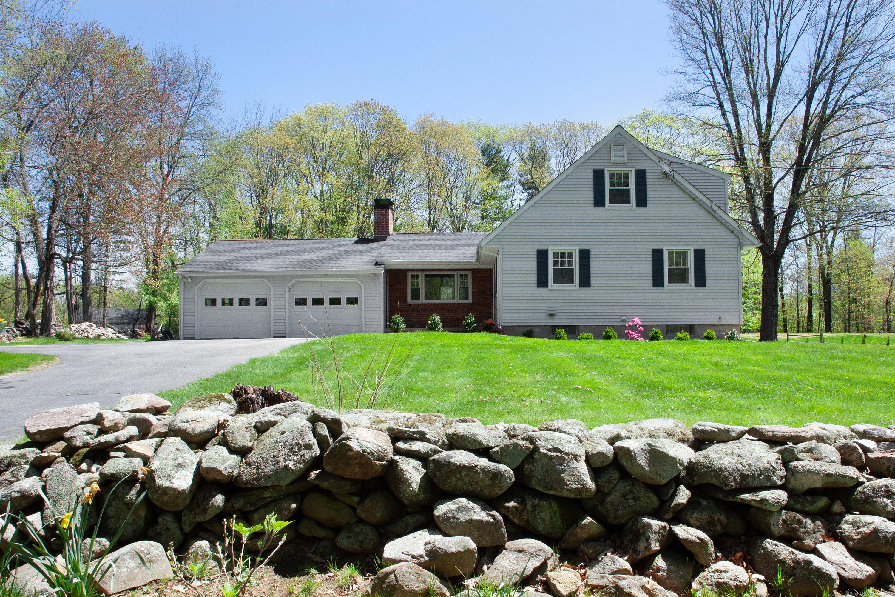 a front view of house with yard and green space