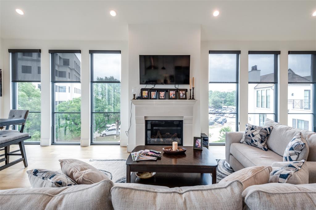 a living room with furniture large window and a fireplace