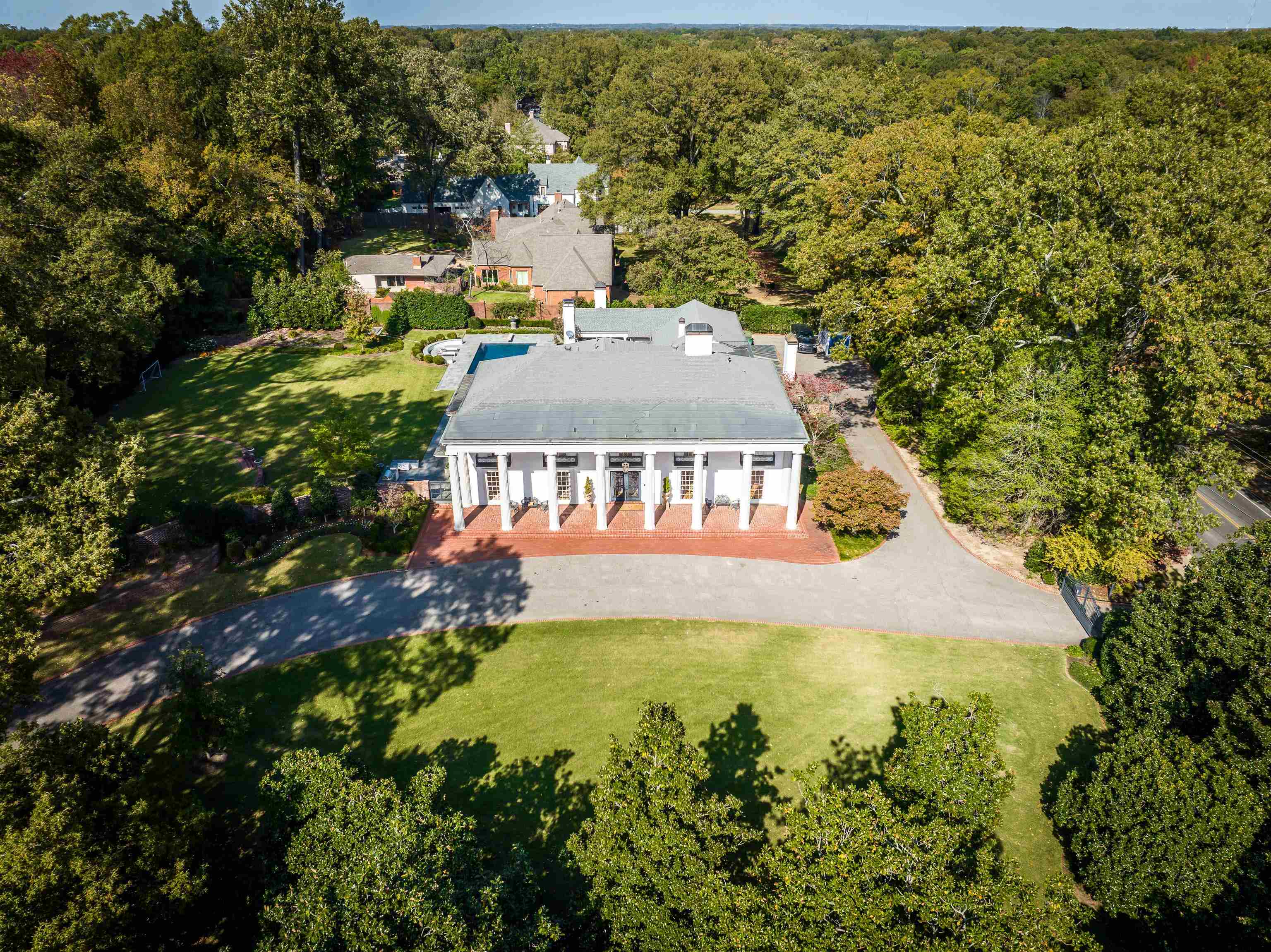 an aerial view of a house with yard swimming pool and outdoor seating