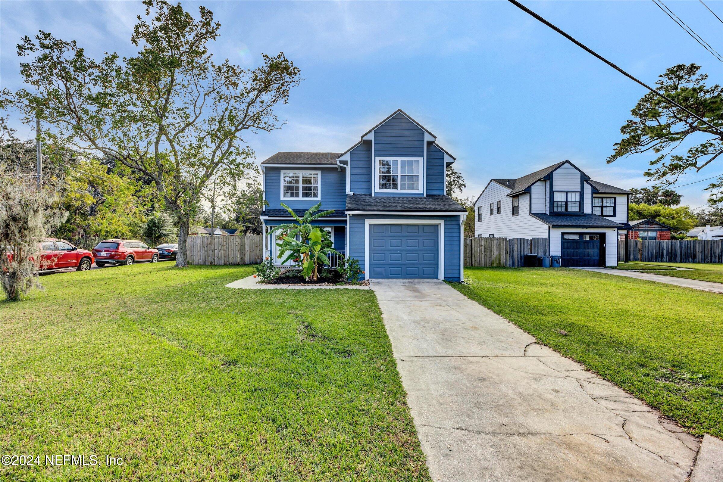 a front view of house with yard and green space