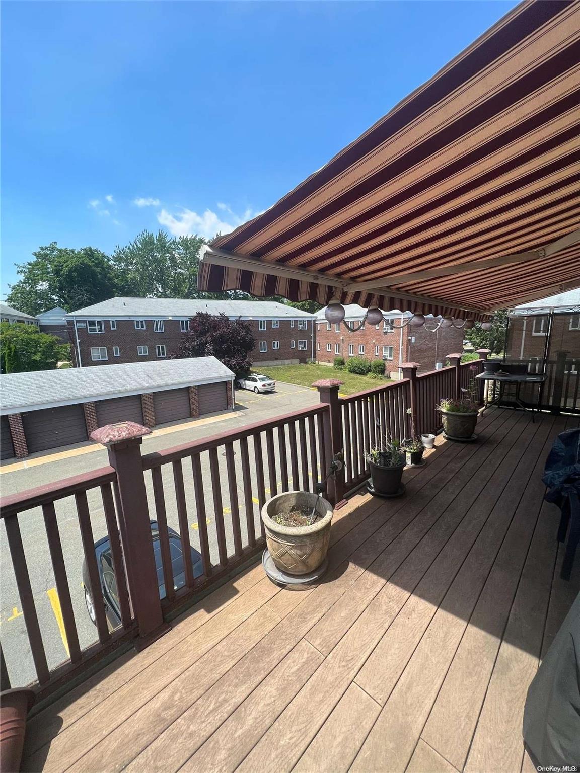 a balcony with hardwood filled with table and chairs