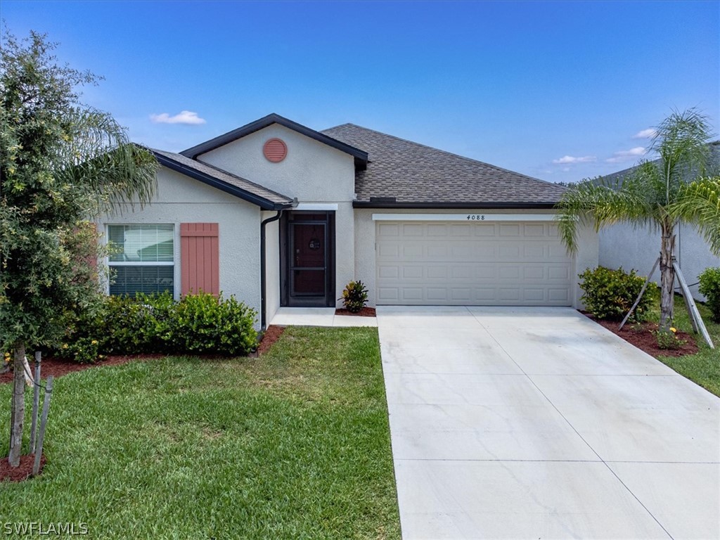 a front view of a house with a yard and garage