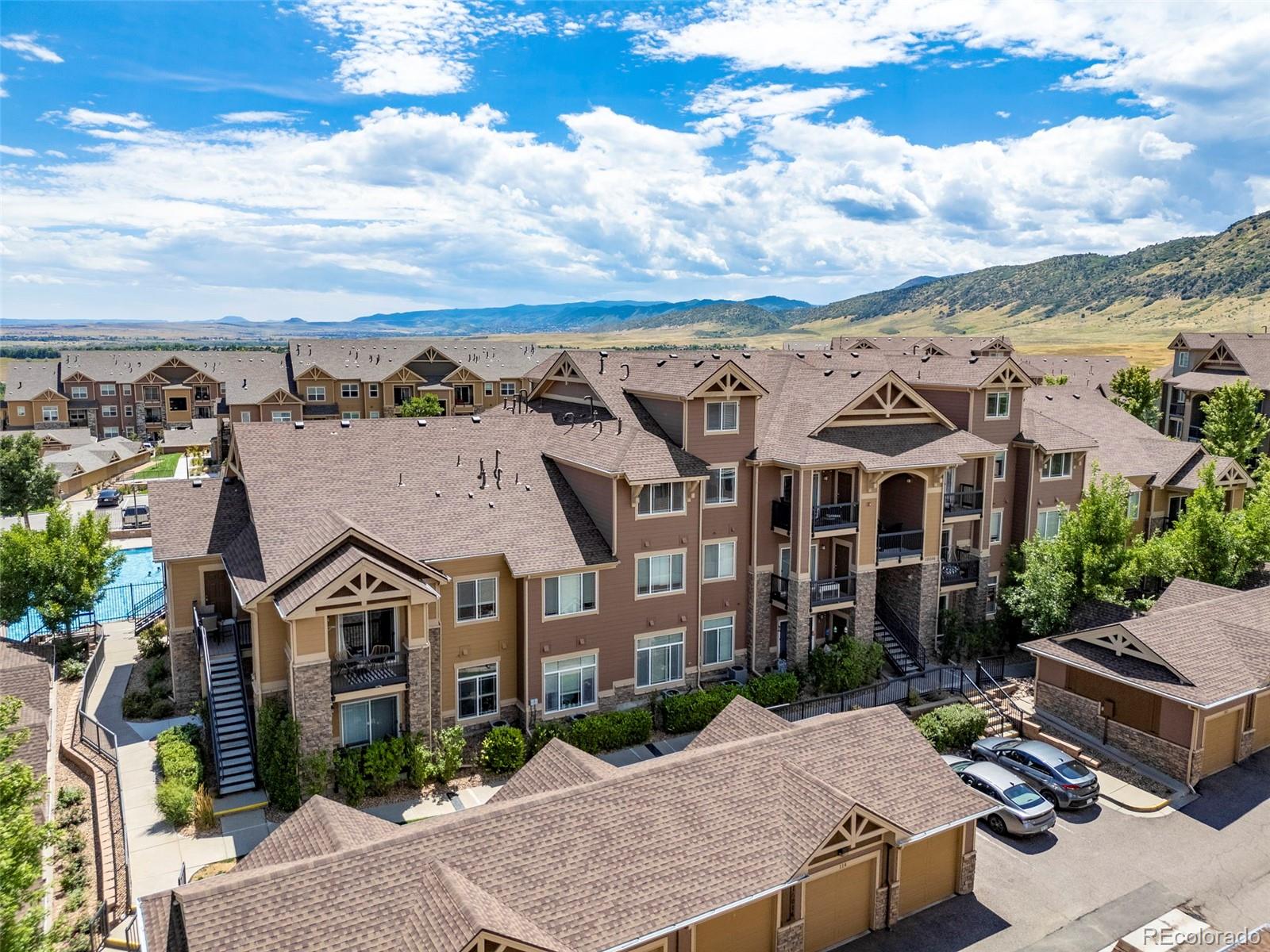 an aerial view of a house with a yard garage and lake view