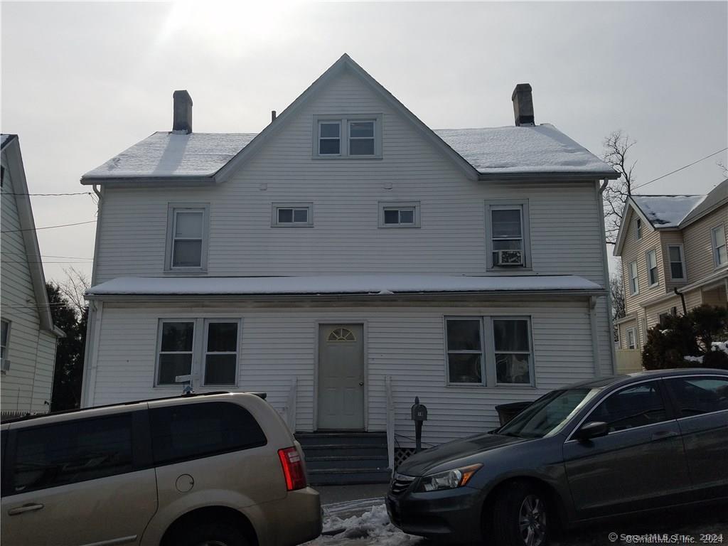 a front view of a house with parking space