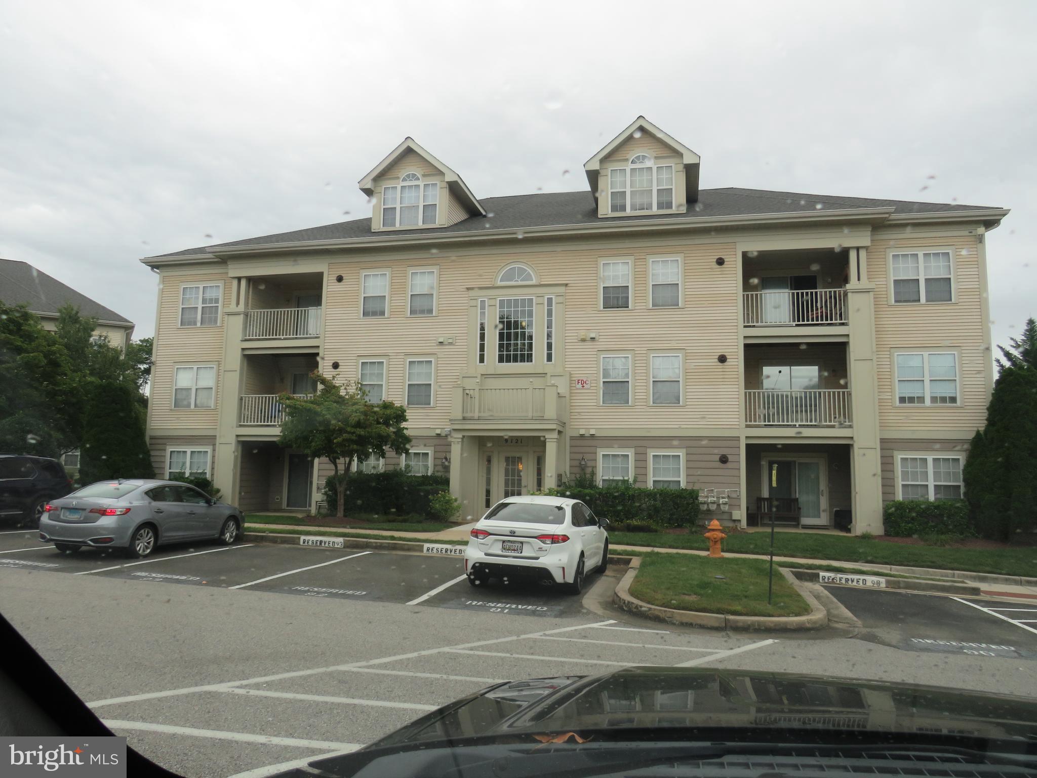 a front view of a residential apartment building with a yard