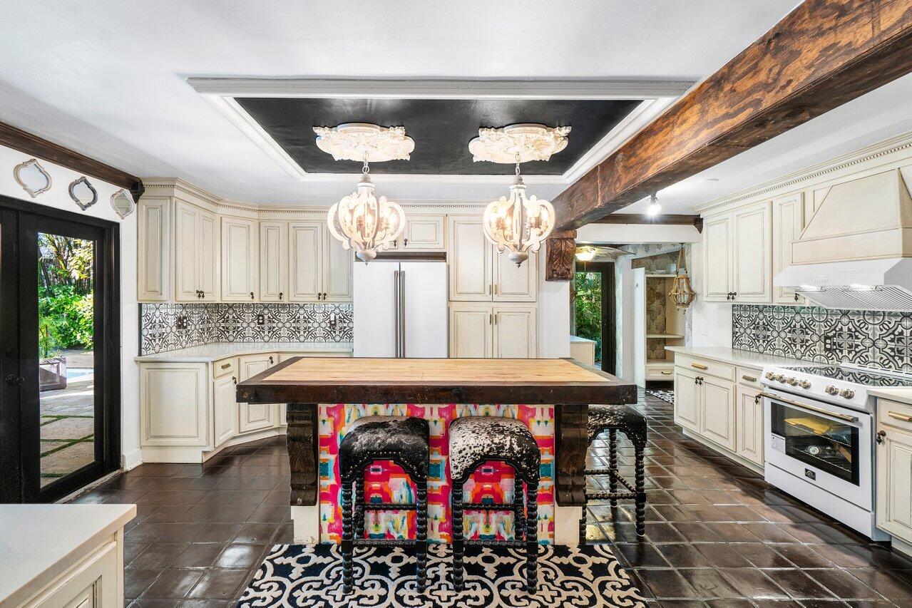 a kitchen with stainless steel appliances granite countertop a stove and cabinets