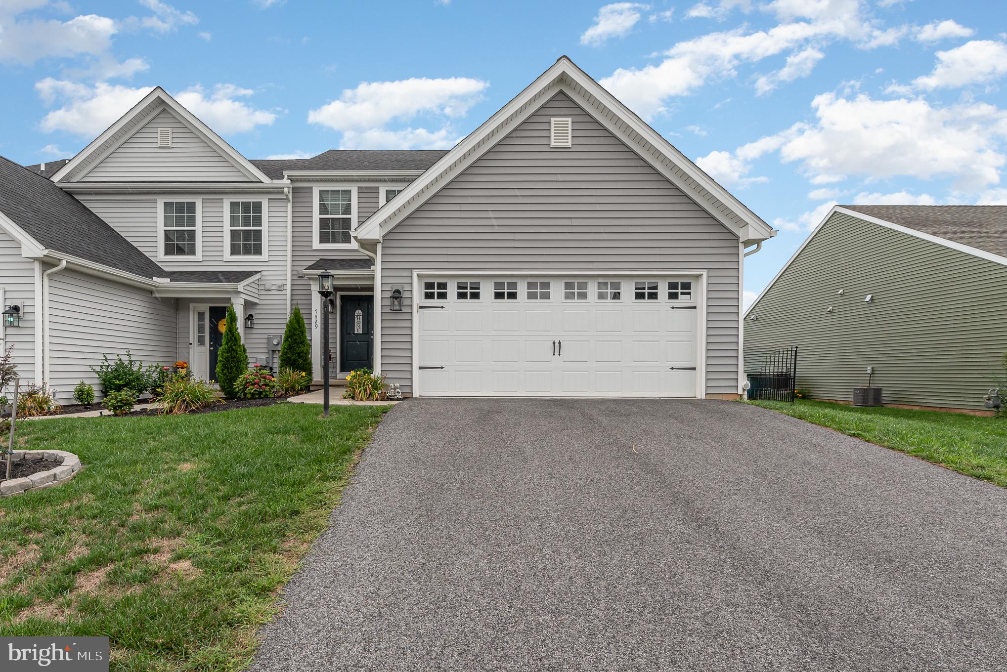 a view of a house with a yard and garage