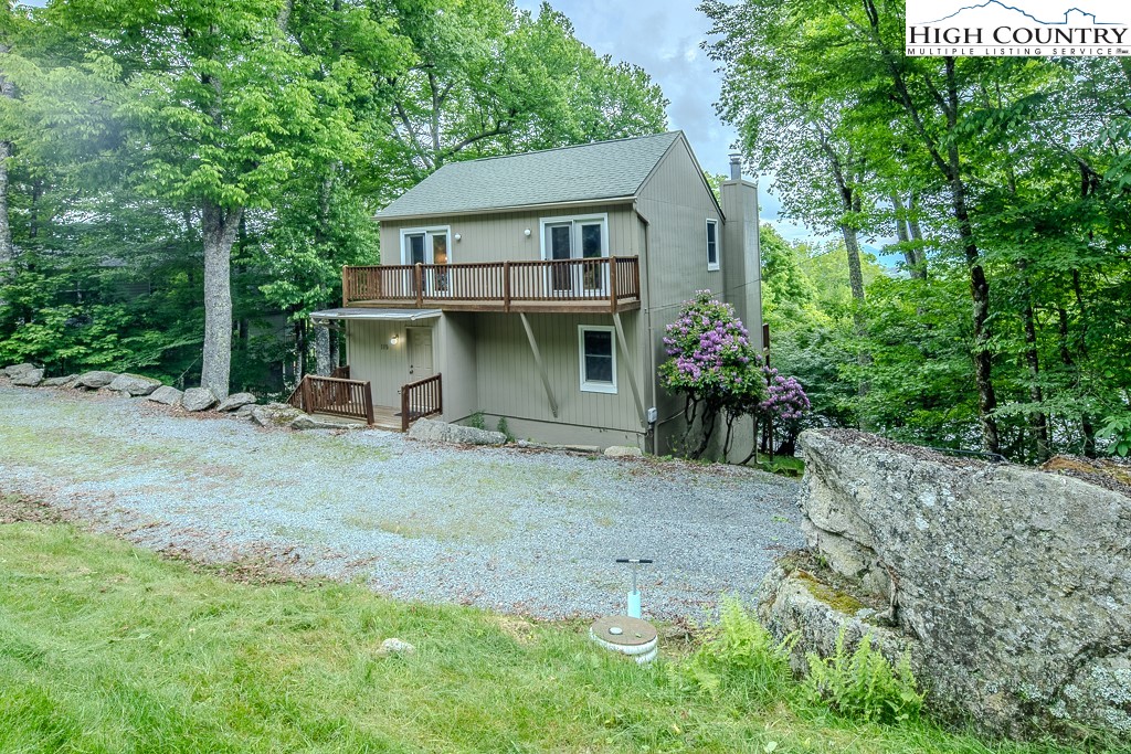 a view of a house with a yard and tree s