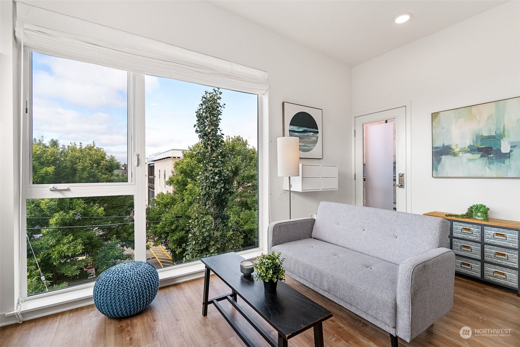 a living room with furniture and a large window