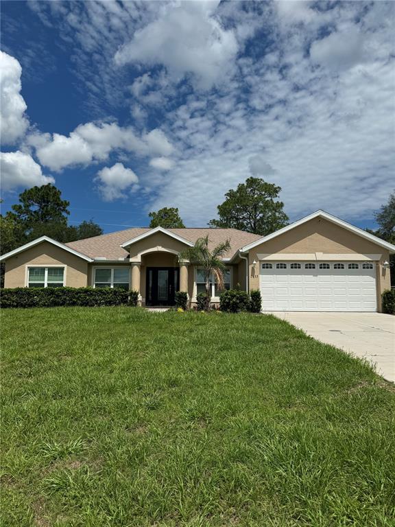 a view of a big house with a big yard and large trees