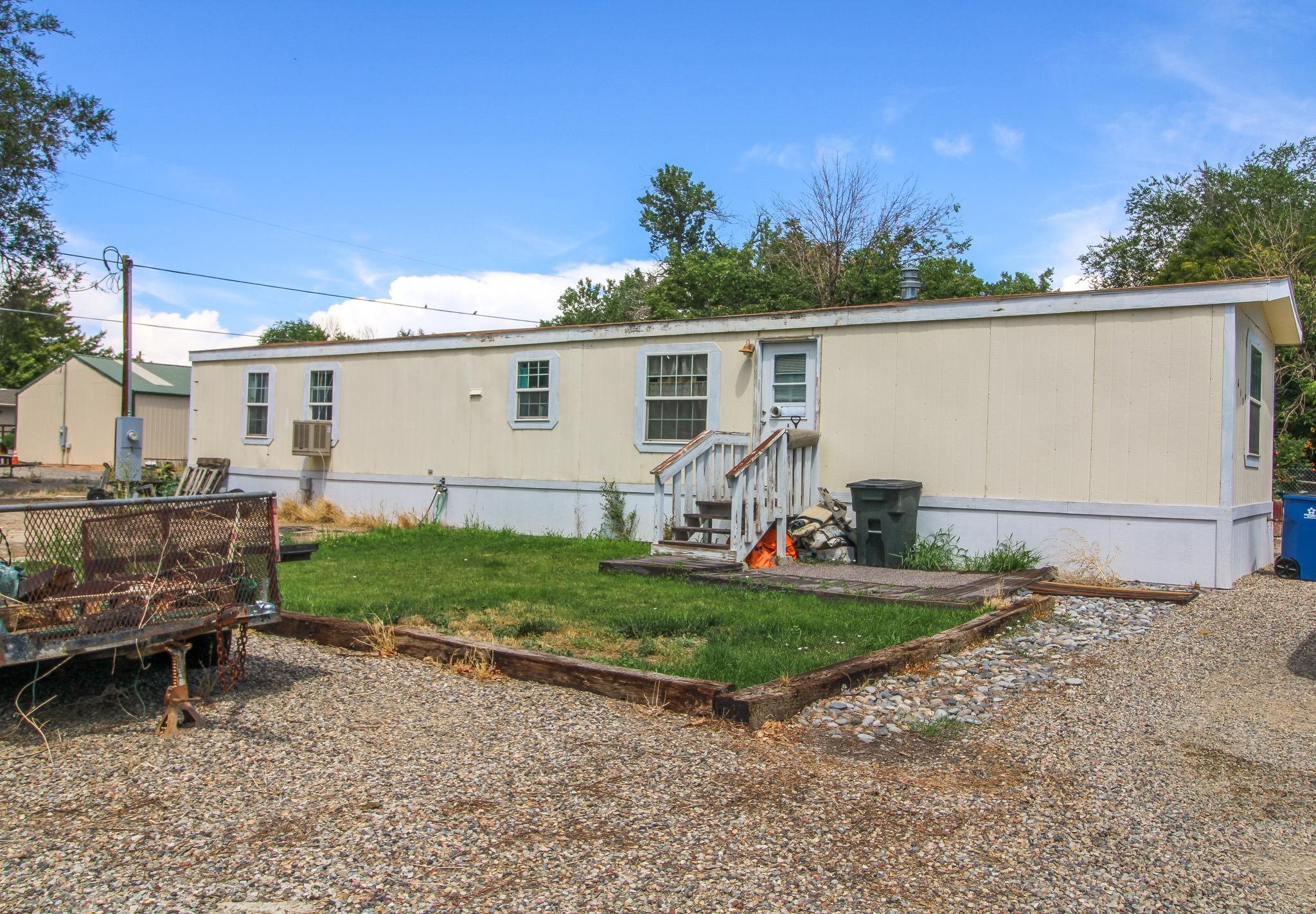 a view of backyard with outdoor seating and plants