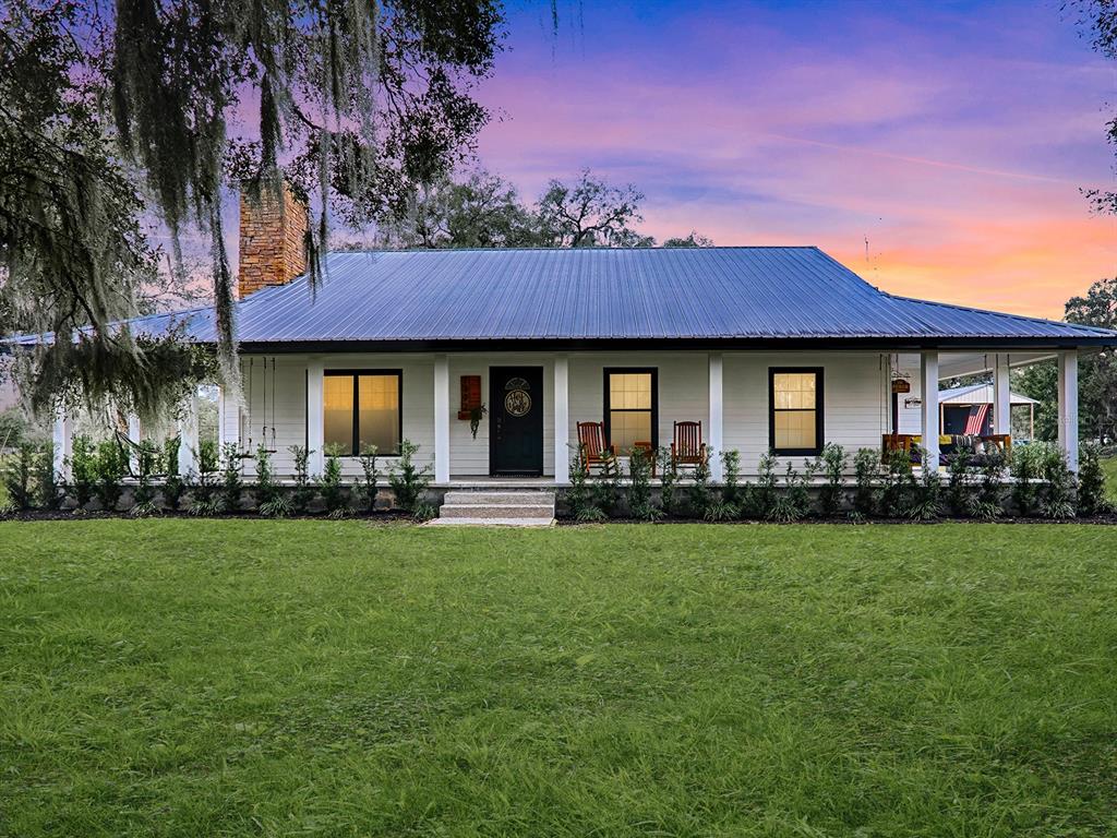 a front view of a house with a garden and porch