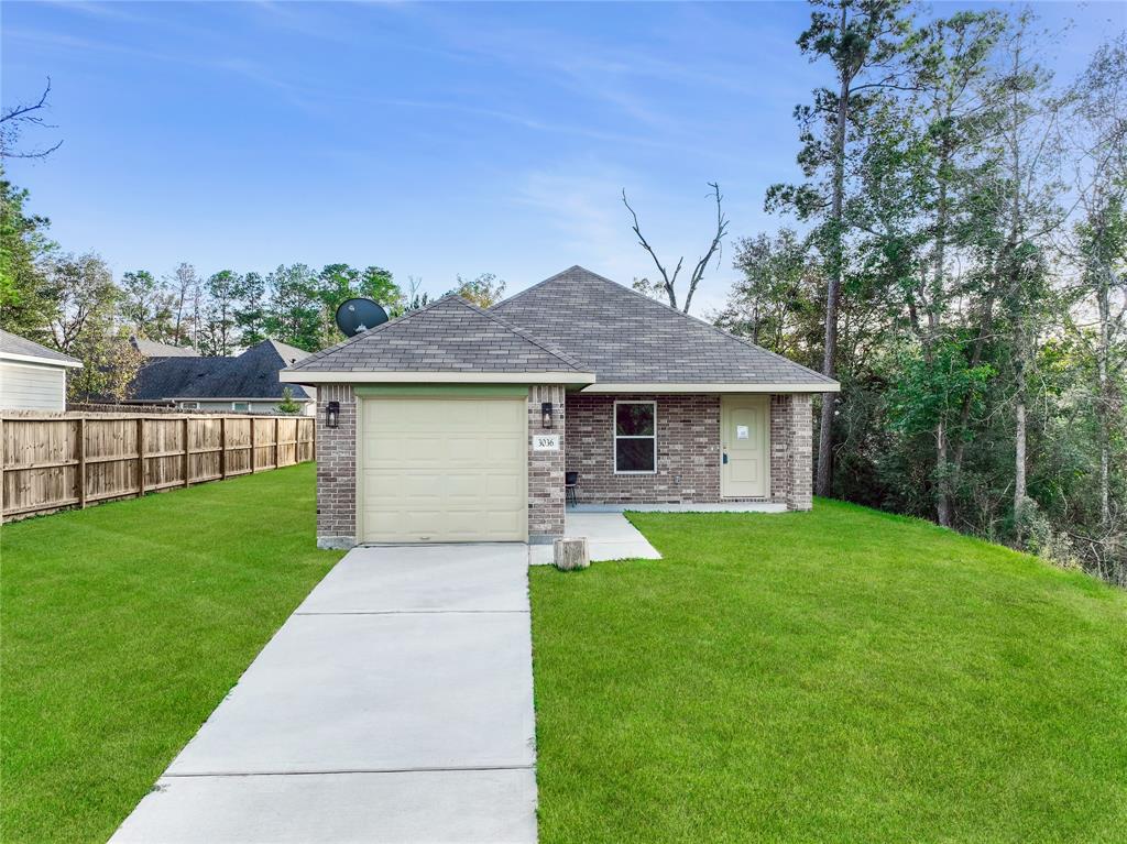 a front view of a house with yard and green space