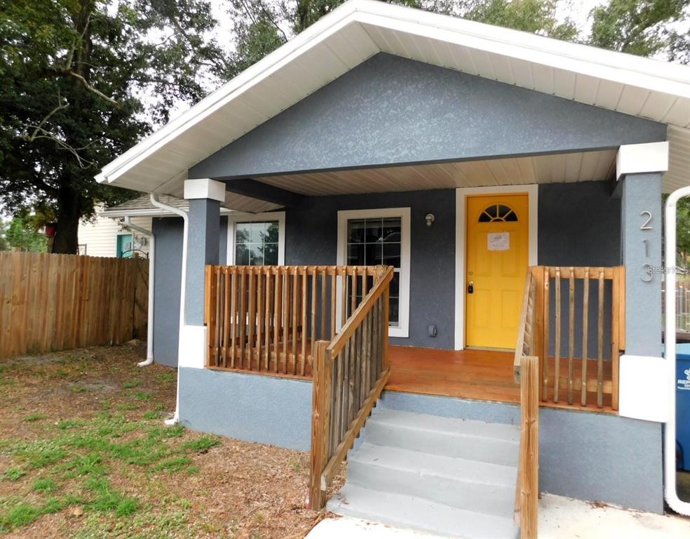 a view of a house with wooden fence