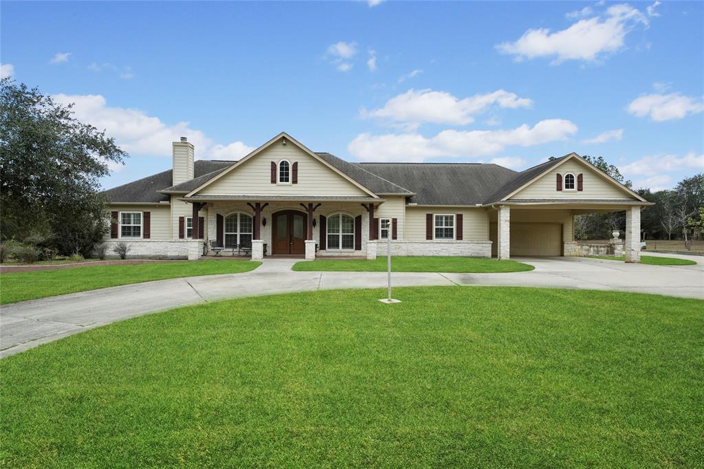 a front view of a house with a garden and yard